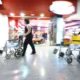 Passenger assistance staff with wheelchairs at Heathrow Airport